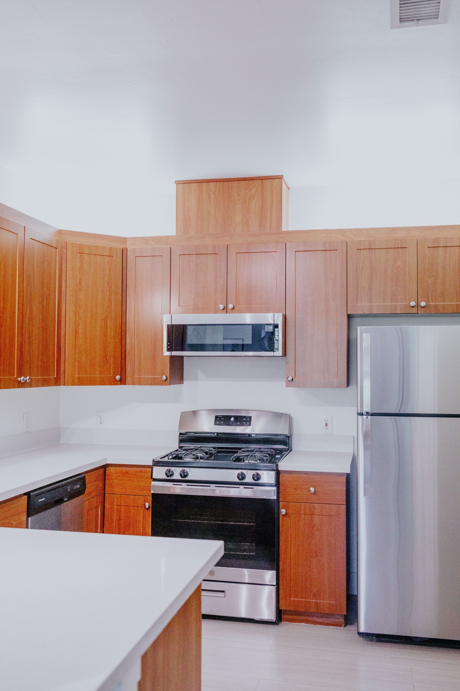 A kitchen with stainless steel appliances and wooden cabinets