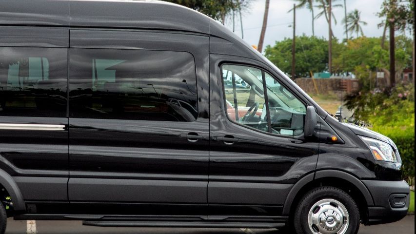 Black passenger van parked outdoors.