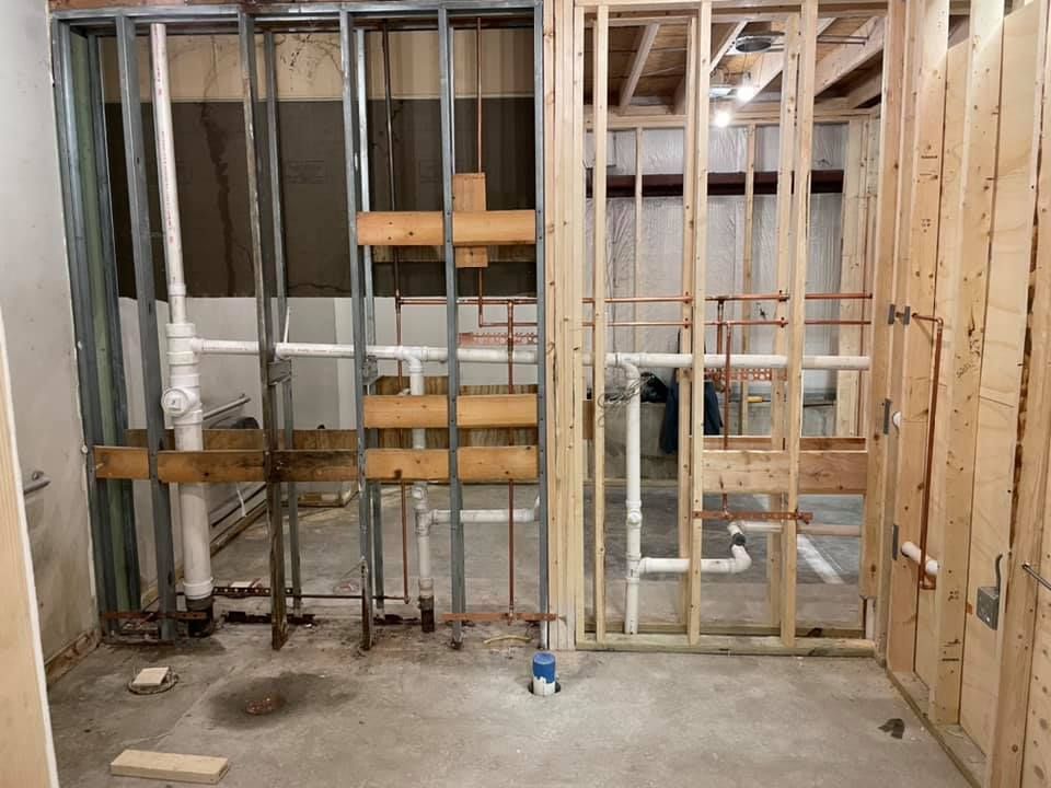 A room with a lot of pipes coming out of it is being built.