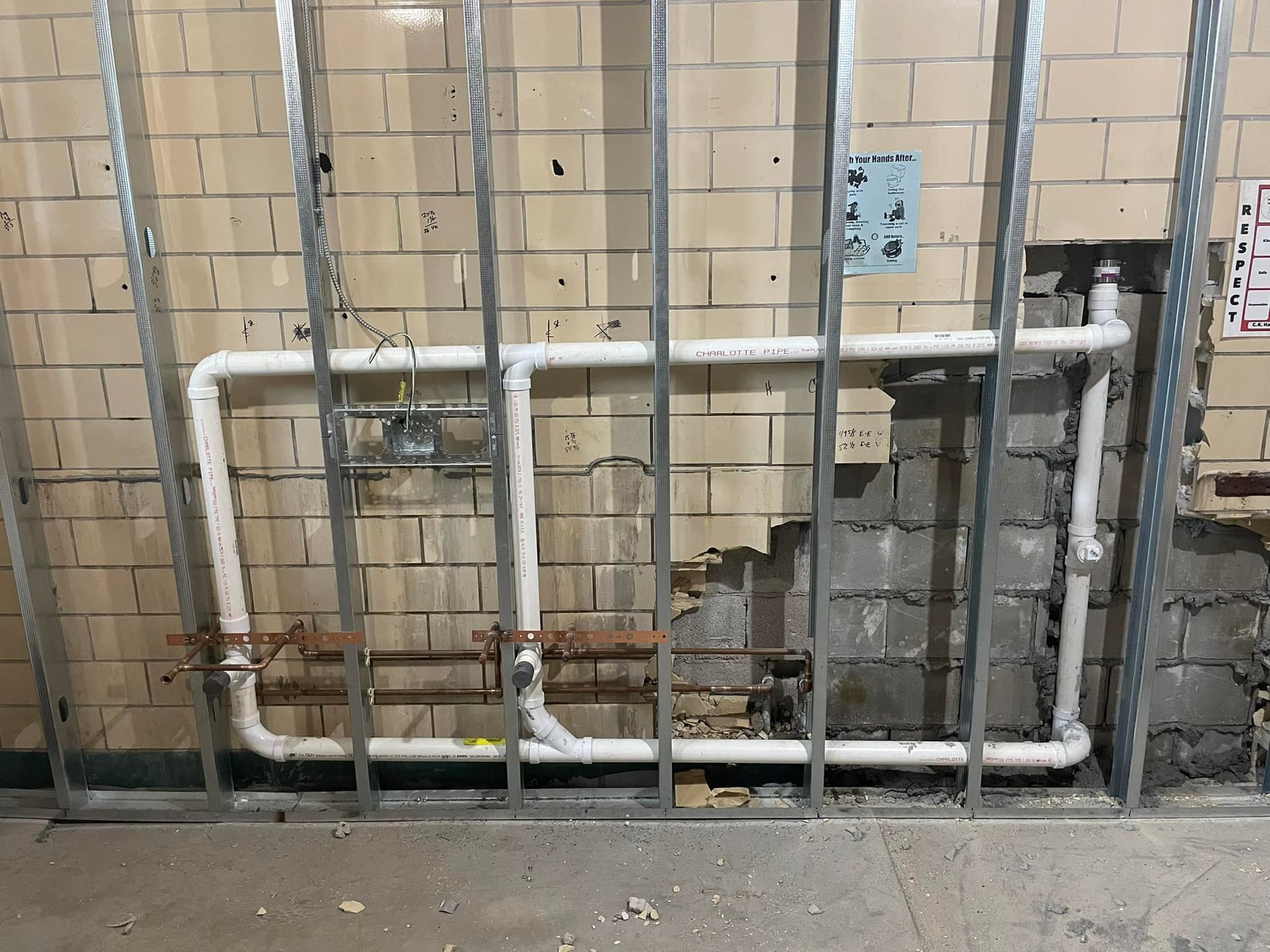A brick wall with pipes coming out of it