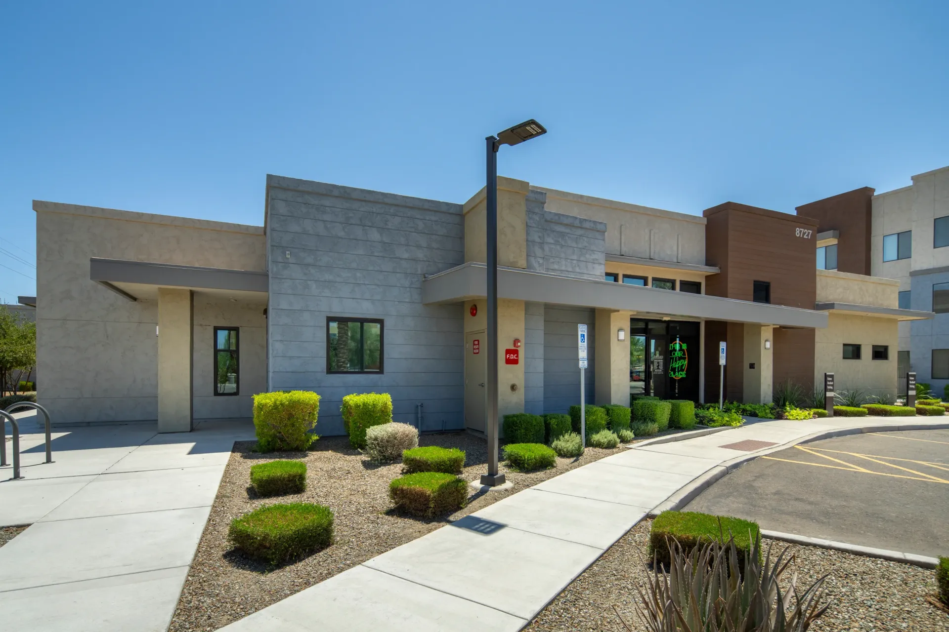 Exterior of the apartment building with modern architecture and landscaping at Parc Lofts in Tolleson, AZ.