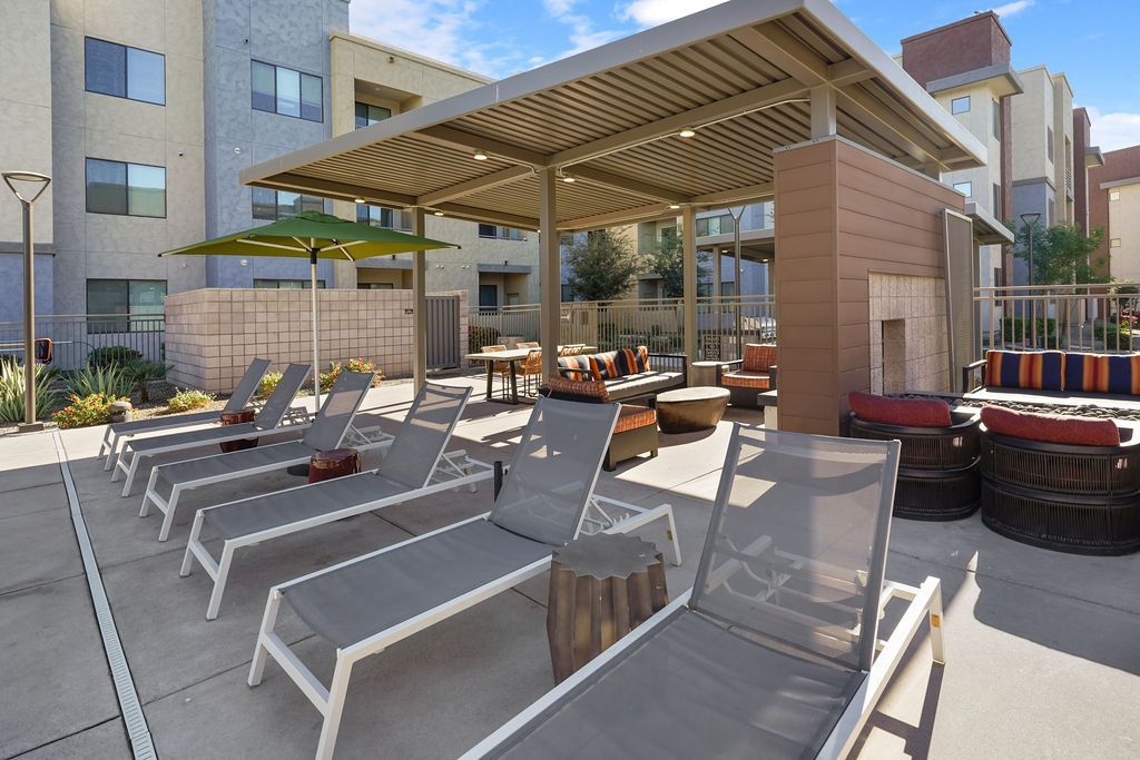 Parc Lofts communal lounge area with sun loungers and a shaded seating pavilion.