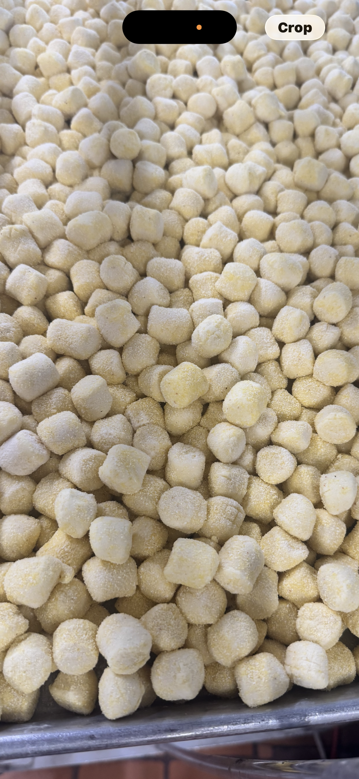 Tray of pale yellow puffed snack pieces or cereal in close-up