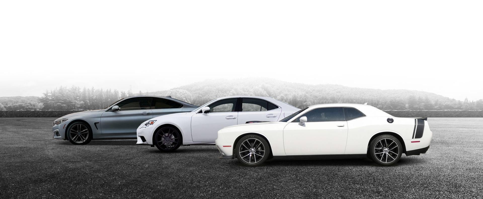 Three sports cars parked side by side on a gravel road, with a foggy landscape behind them. | New Pegasus Automotive