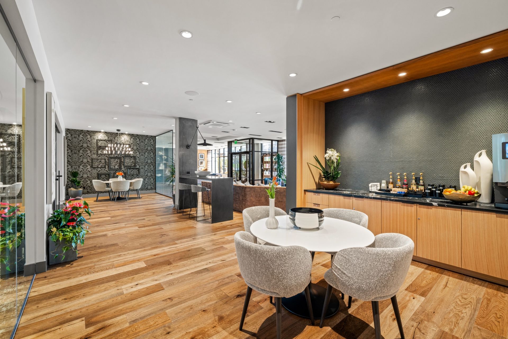 Apartment leasing office with chairs and sofa.