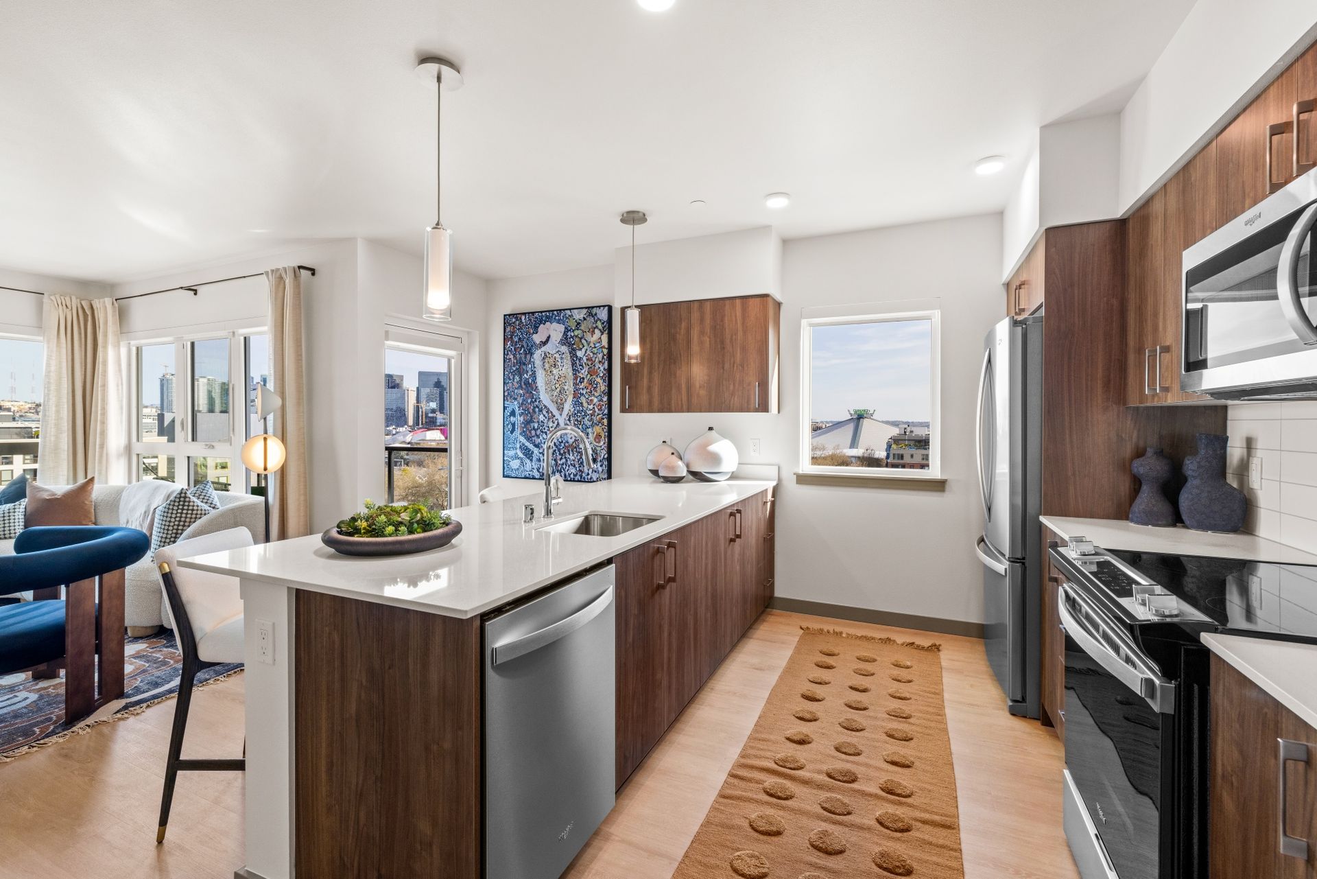 A kitchen with stainless steel appliances and wooden cabinets.