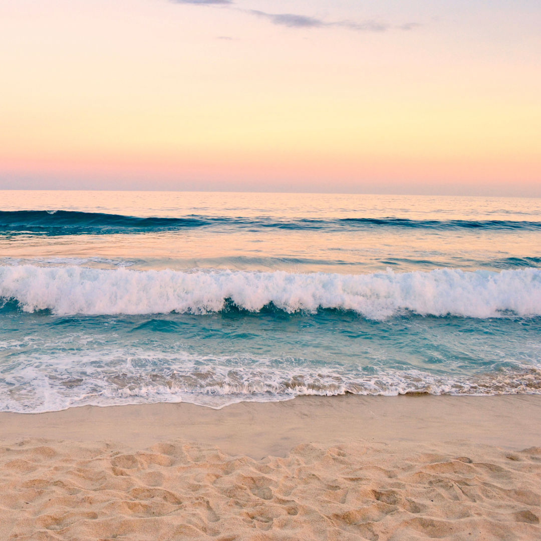The turquoise water's edge on a sunny morning at the beach