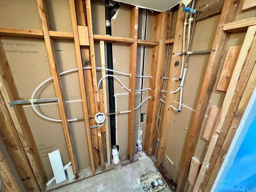 New construction plumbing being performed by a man