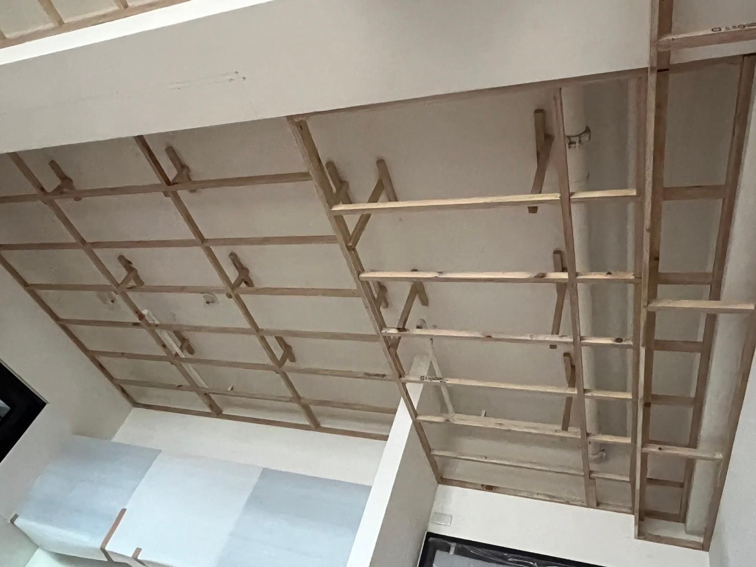 A ceiling with a lot of wooden beams hanging from it.