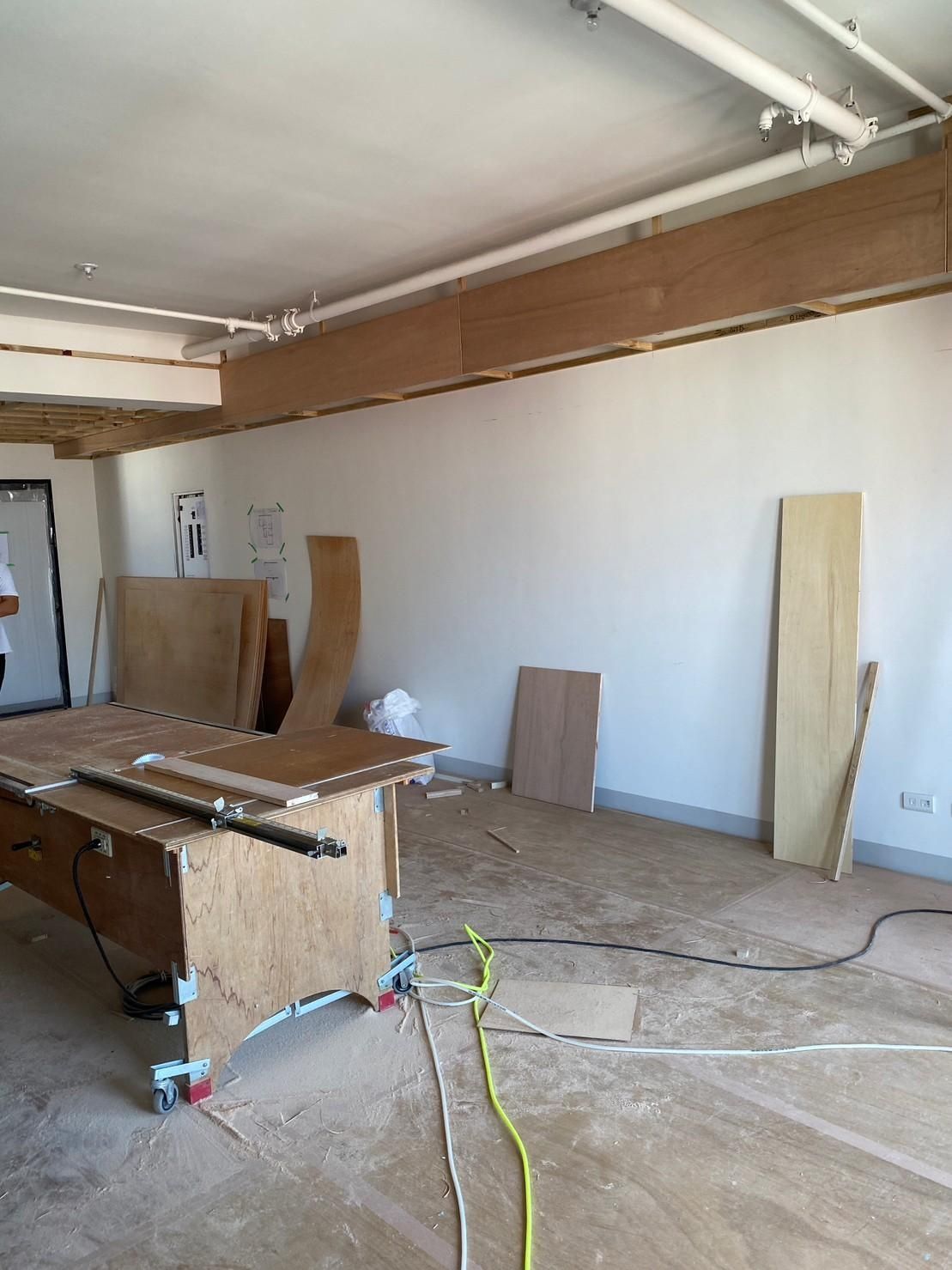 A room with a table and a lot of wood in it.