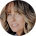 Close-up portrait of a woman with shoulder-length light brown hair, smiling softly against a white background