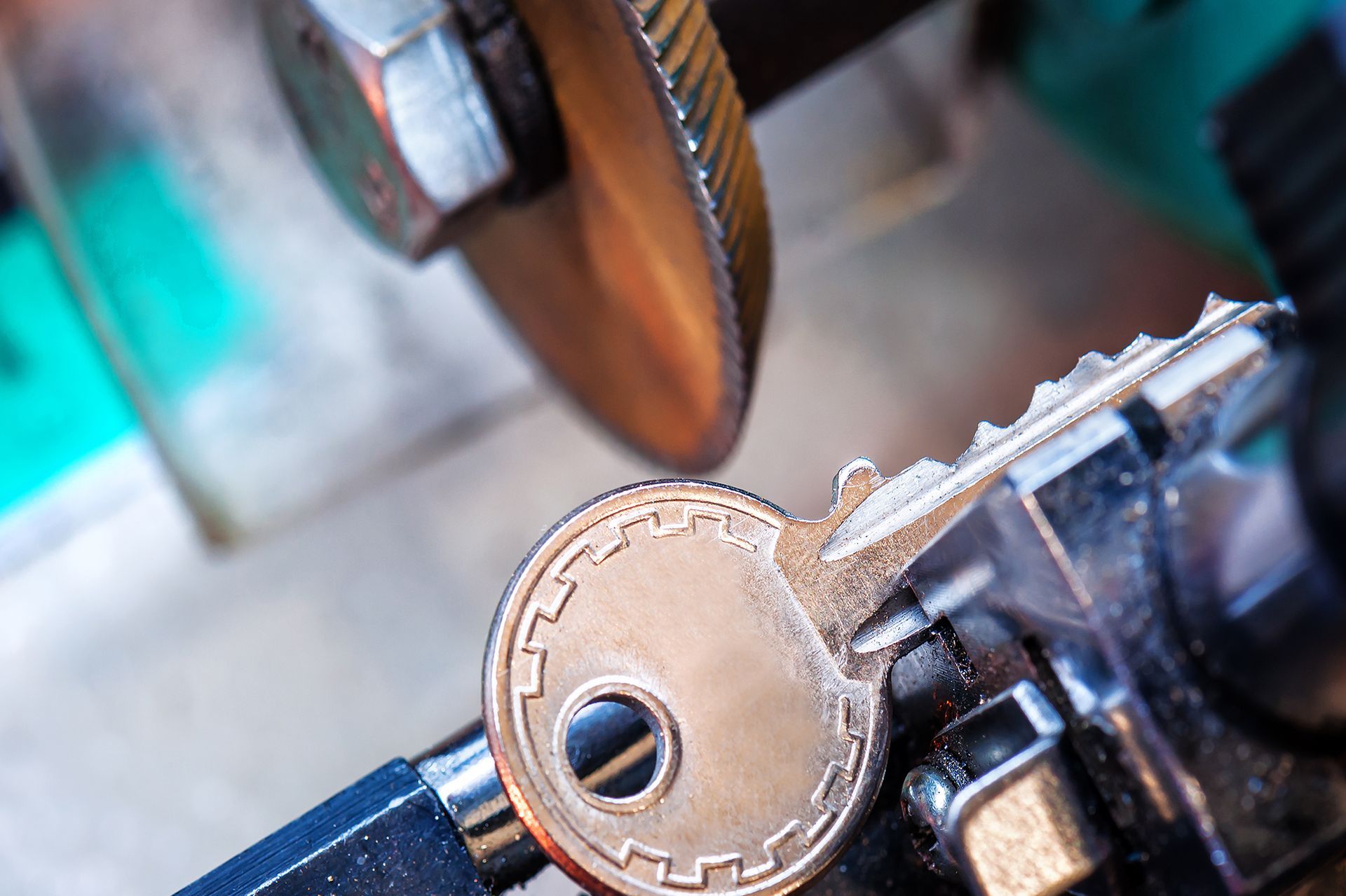 A close up of a key being cut by a machine.