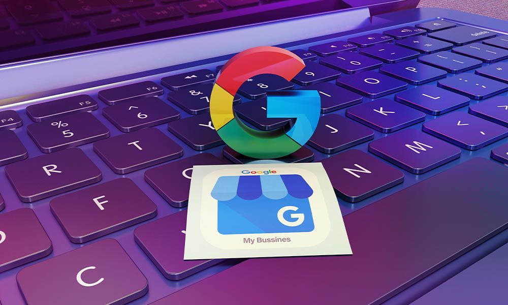 A google logo is sitting on top of a laptop keyboard.