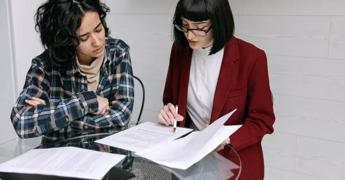 Two professionals review documents together, comparing detailers roadmap vs shop positioner strategies at a desk.