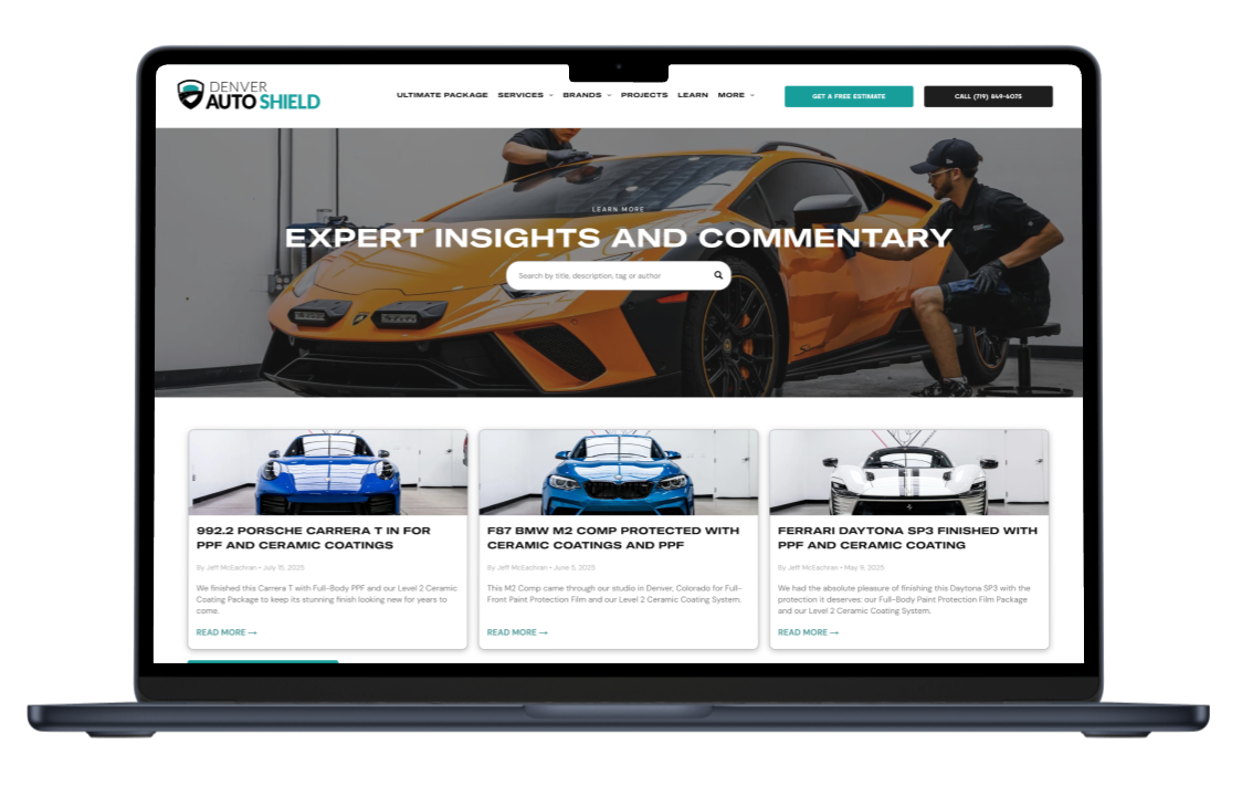 Laptop displaying a website about car protection, with articles and a man working on a sports car.