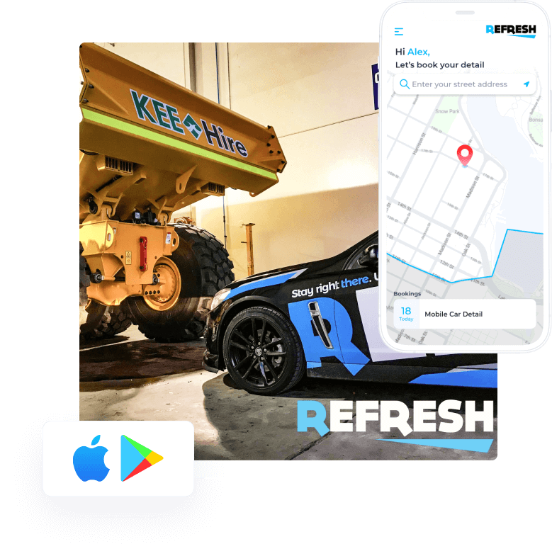 A blue car is parked next to a large dump truck.