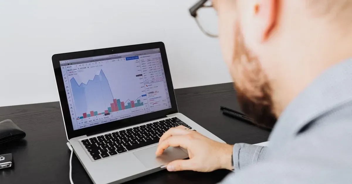 Man analyzing detailed agency niche performance metrics and analytics charts on laptop screen.