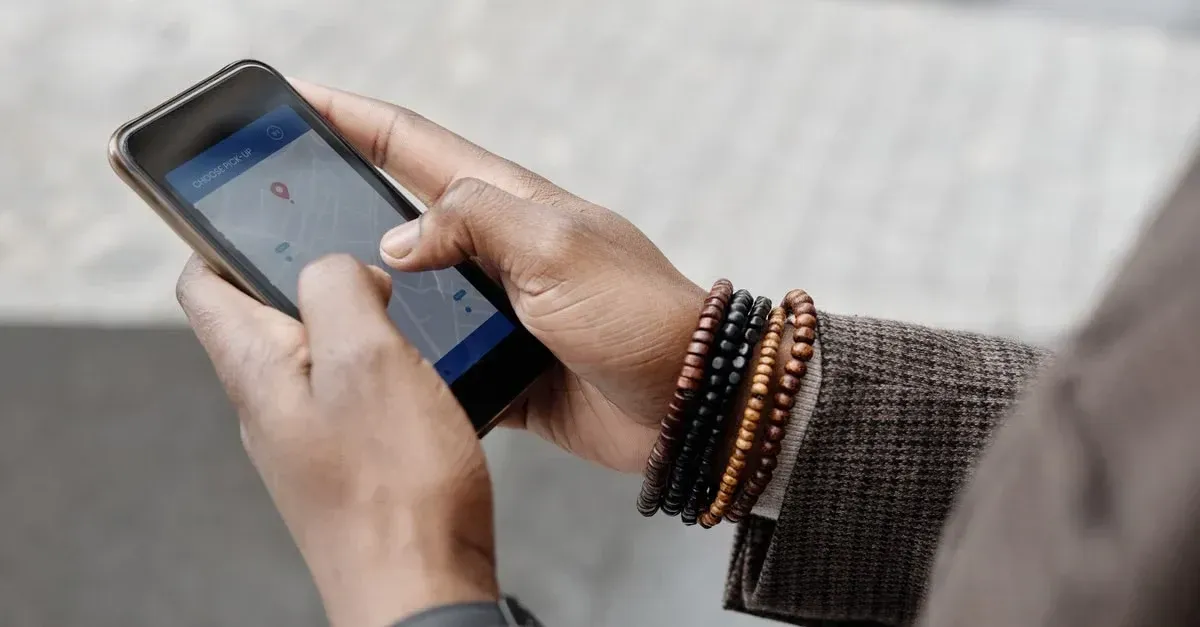 Person holding smartphone displaying map interface with location pin for local search navigation.