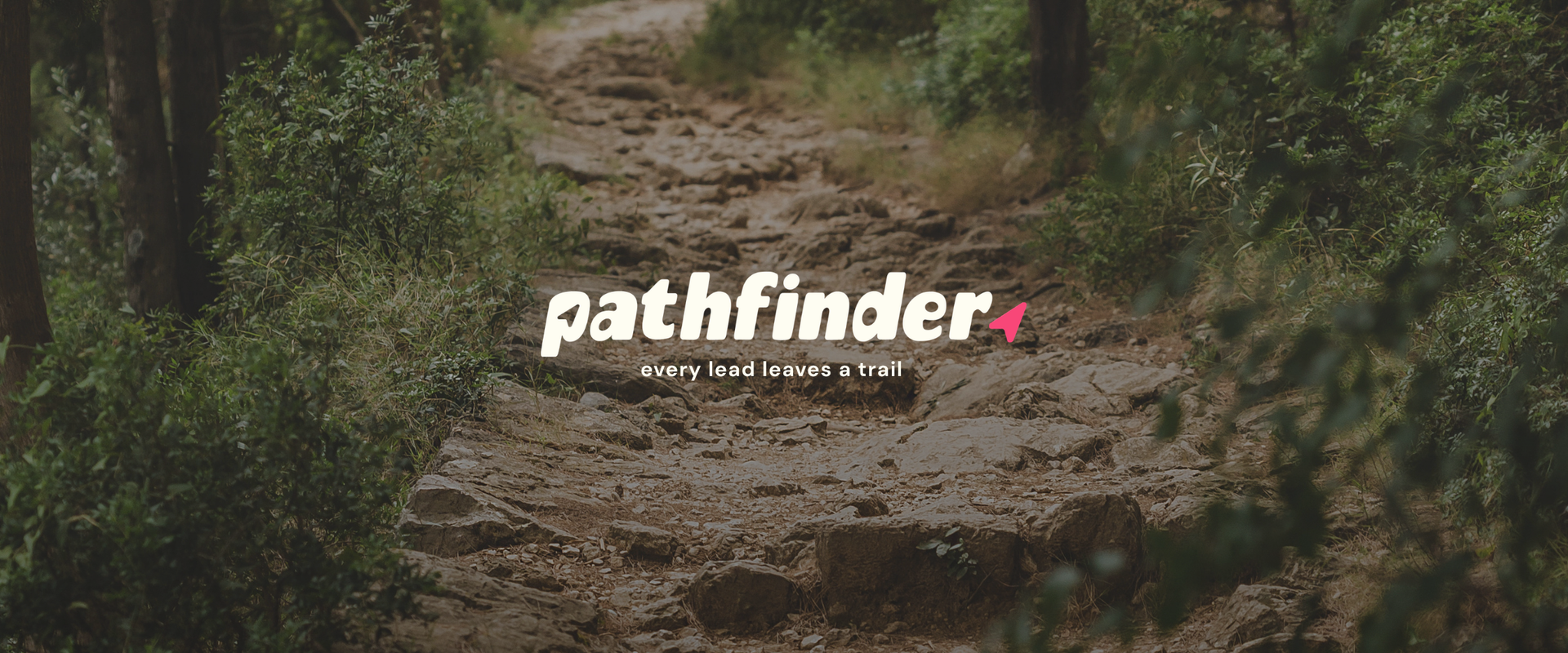 Mud-covered forest trail with the word “pathfinder” overlaid in white and pink text