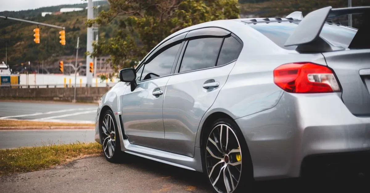 Silver sedan with professional window tinting showcasing quality workmanship for window tinting SEO agency visibility.