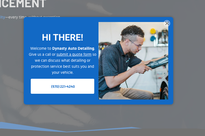 Blue pop-up ad reading “HI THERE!” with a worker using a laptop on the right and a call-to-action button below.