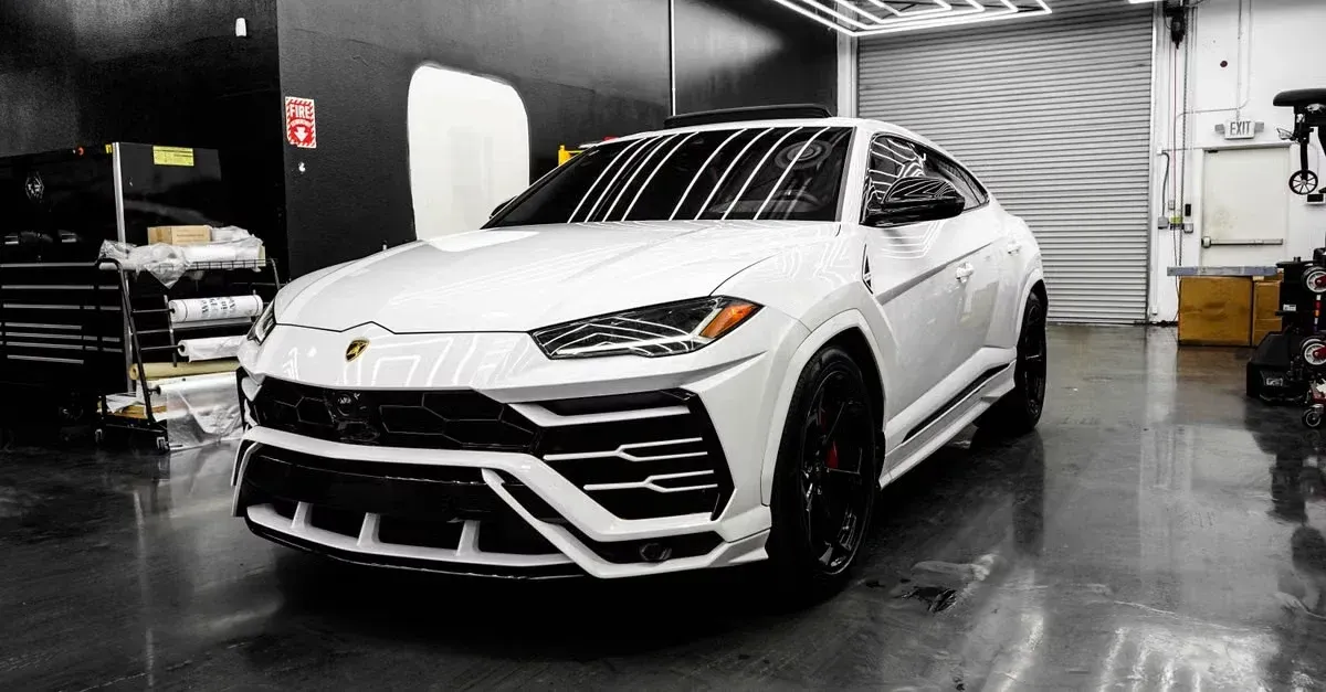White Lamborghini SUV in professional detailing shop showcasing premium car detailing to get more detailing clients.