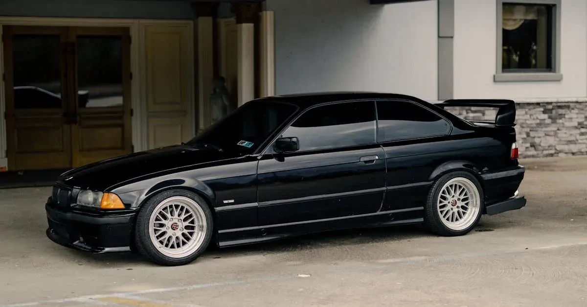 Black sedan with professional window tinting parked in garage, showcasing quality tint application by window tinting service.