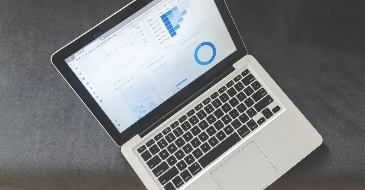 Laptop displaying window tint advertising analytics dashboard with performance metrics and conversion data graphs.