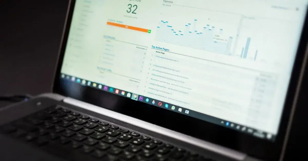 Laptop screen displaying conversion rate calculator dashboard with metrics, orange progress bar, and