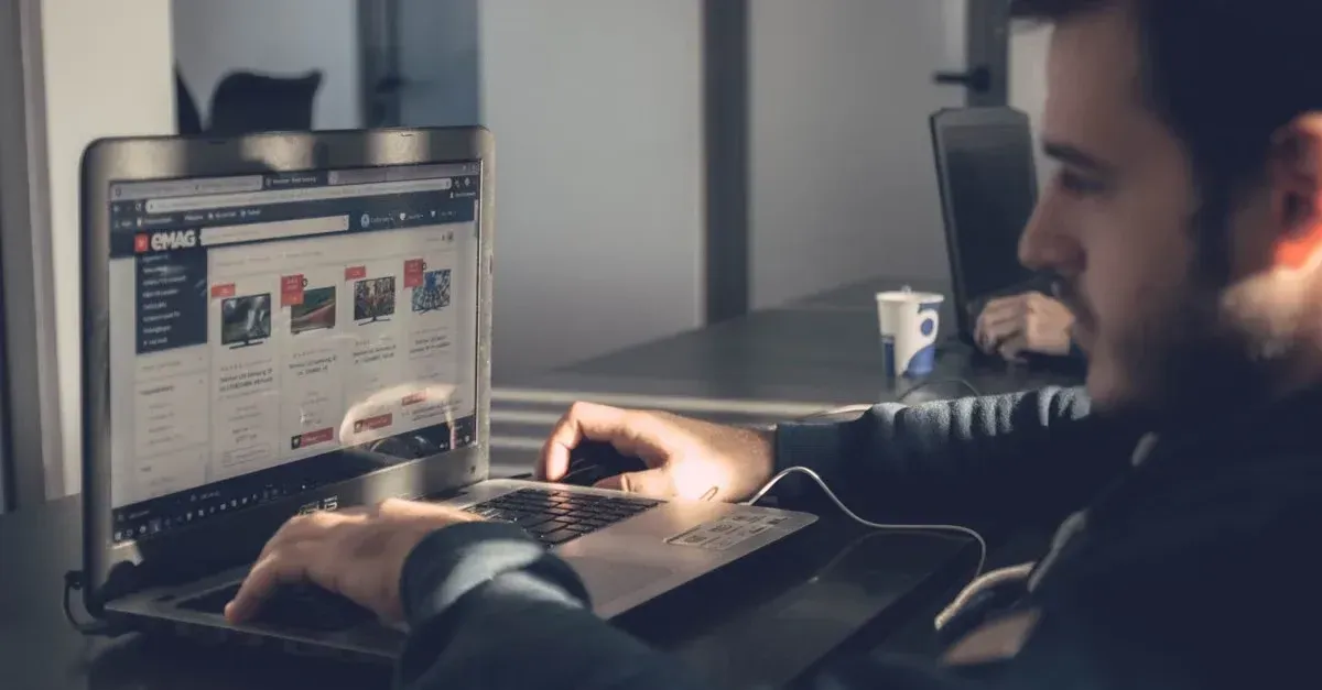 Man analyzing website analytics on laptop monitor, troubleshooting why SEO not working effectively.