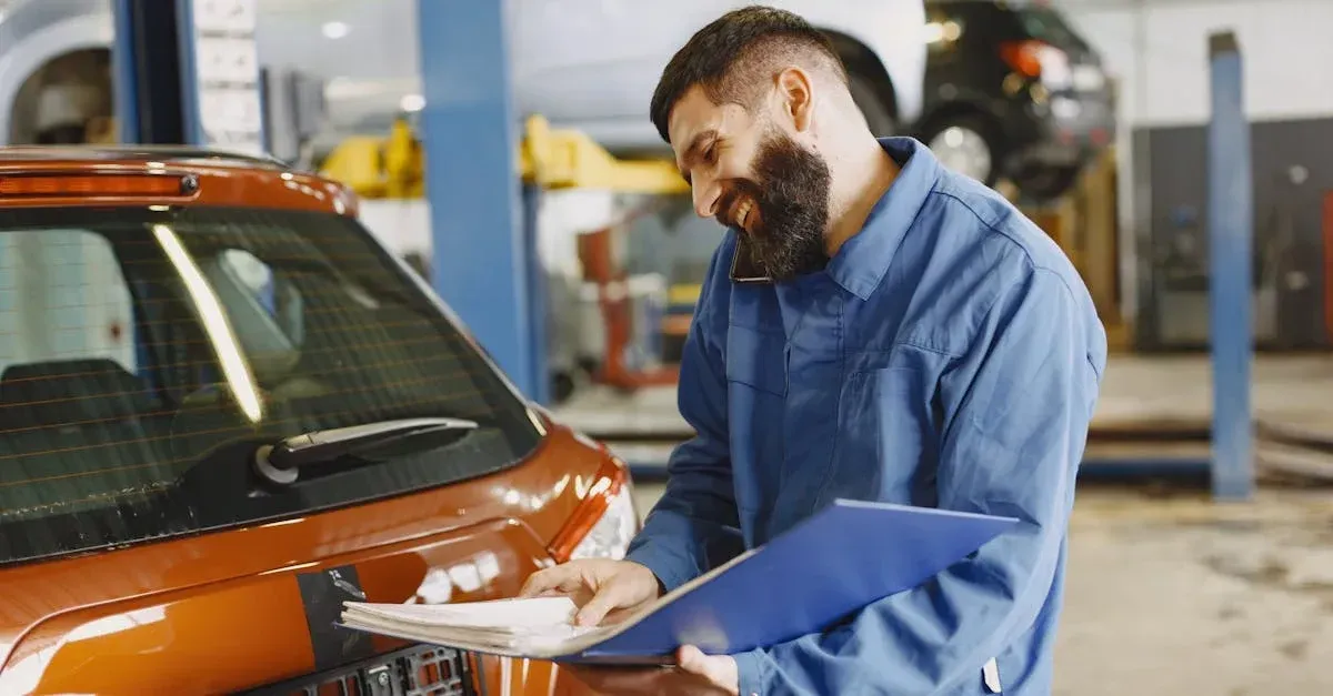 Mechanic in blue uniform inspecting orange car with clipboard in workshop garage setting.