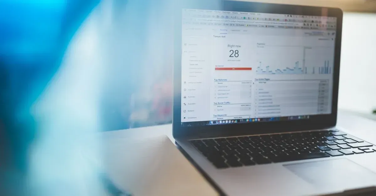 Laptop displaying analytics dashboard with SEO ROI calculator metrics and performance graphs for revenue tracking.