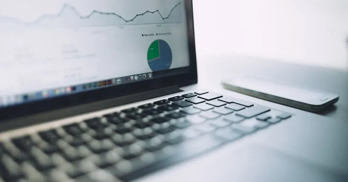 Laptop displaying analytics dashboard with line graph and pie chart for window tint SEO performance tracking.