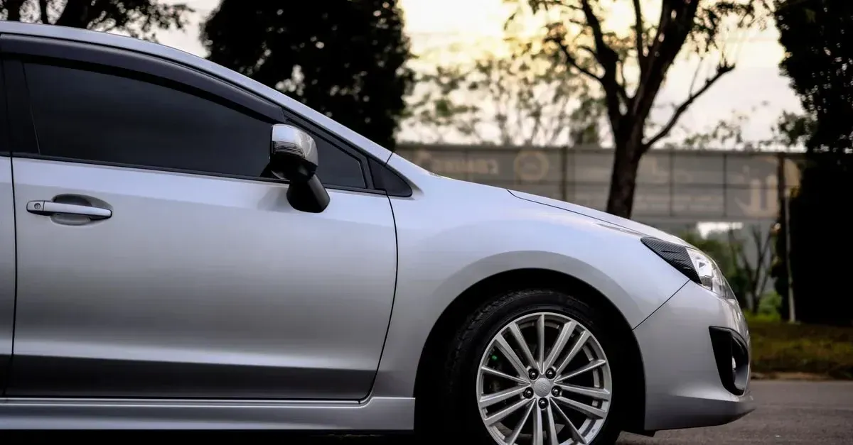Silver sedan with professional window tinting showcasing sleek dark-tinted windows.