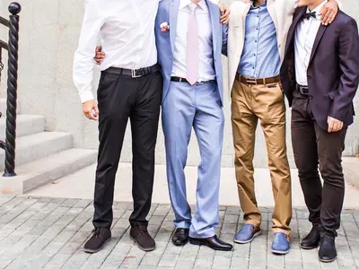A group of men in suits and ties are posing for a picture.