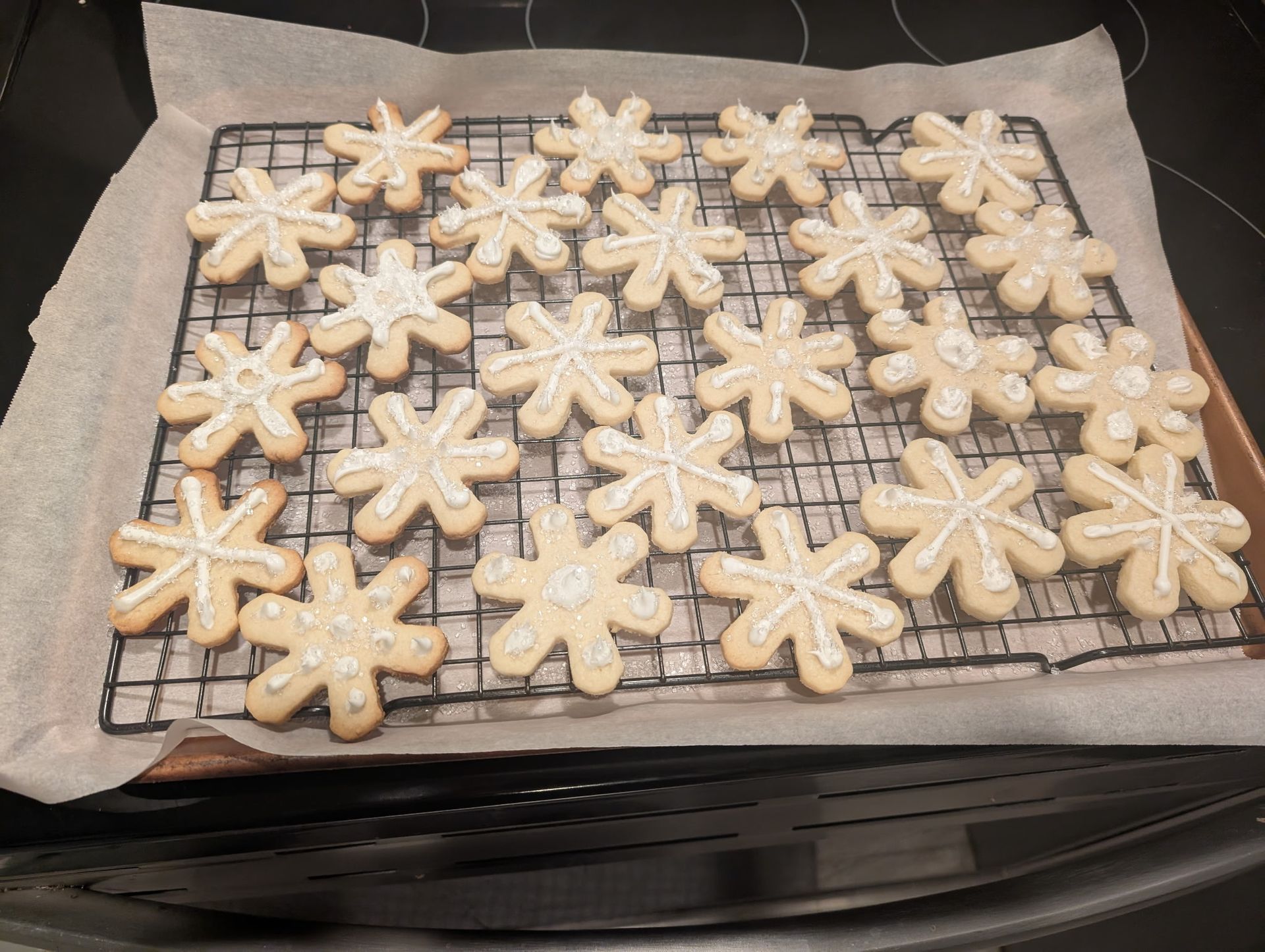 A row of peanut butter cookies sitting on top of a cooling rack.