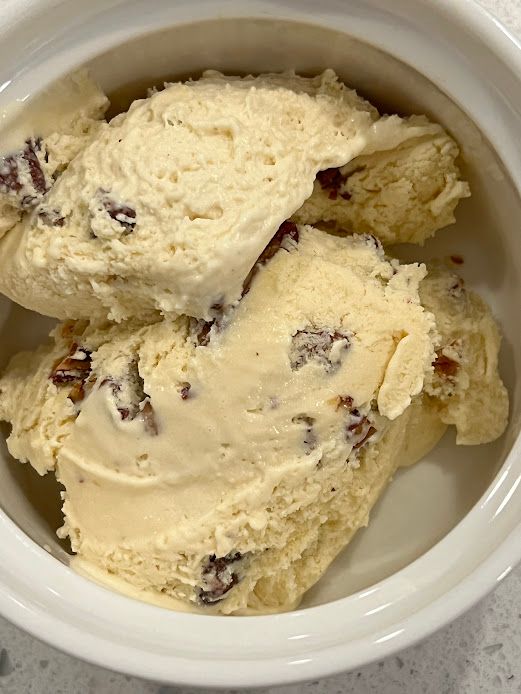 A bowl of butter pecan ice cream.