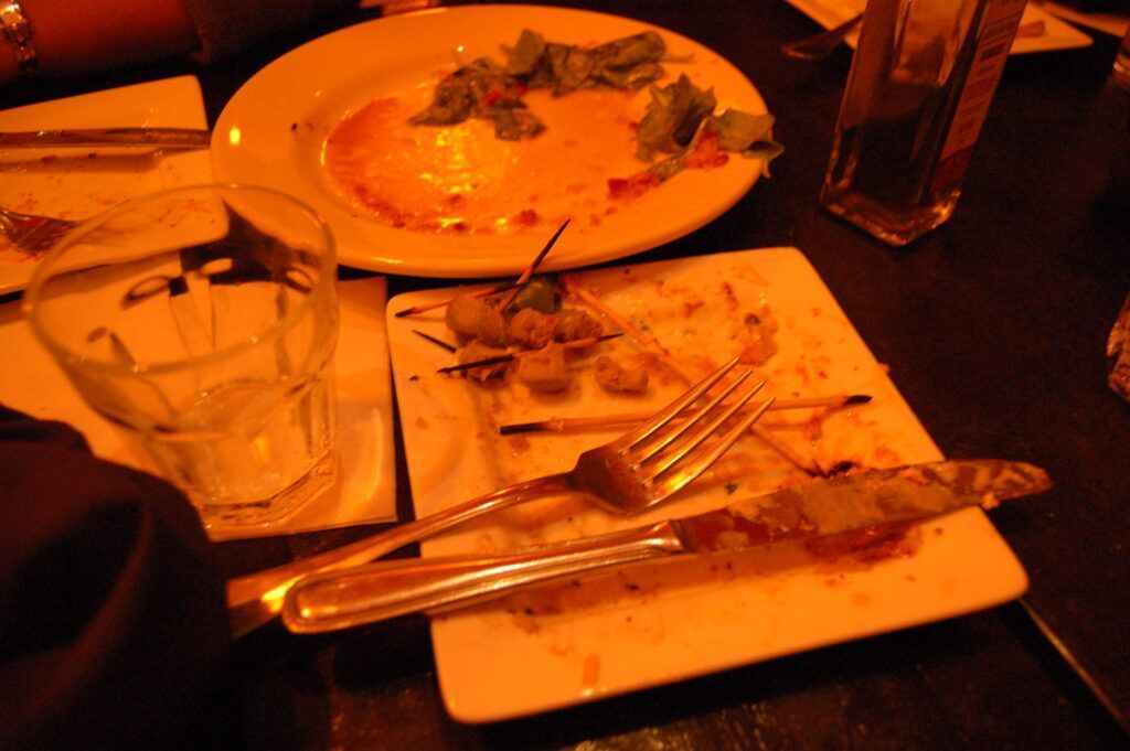 A dirty plate of food sits on a table