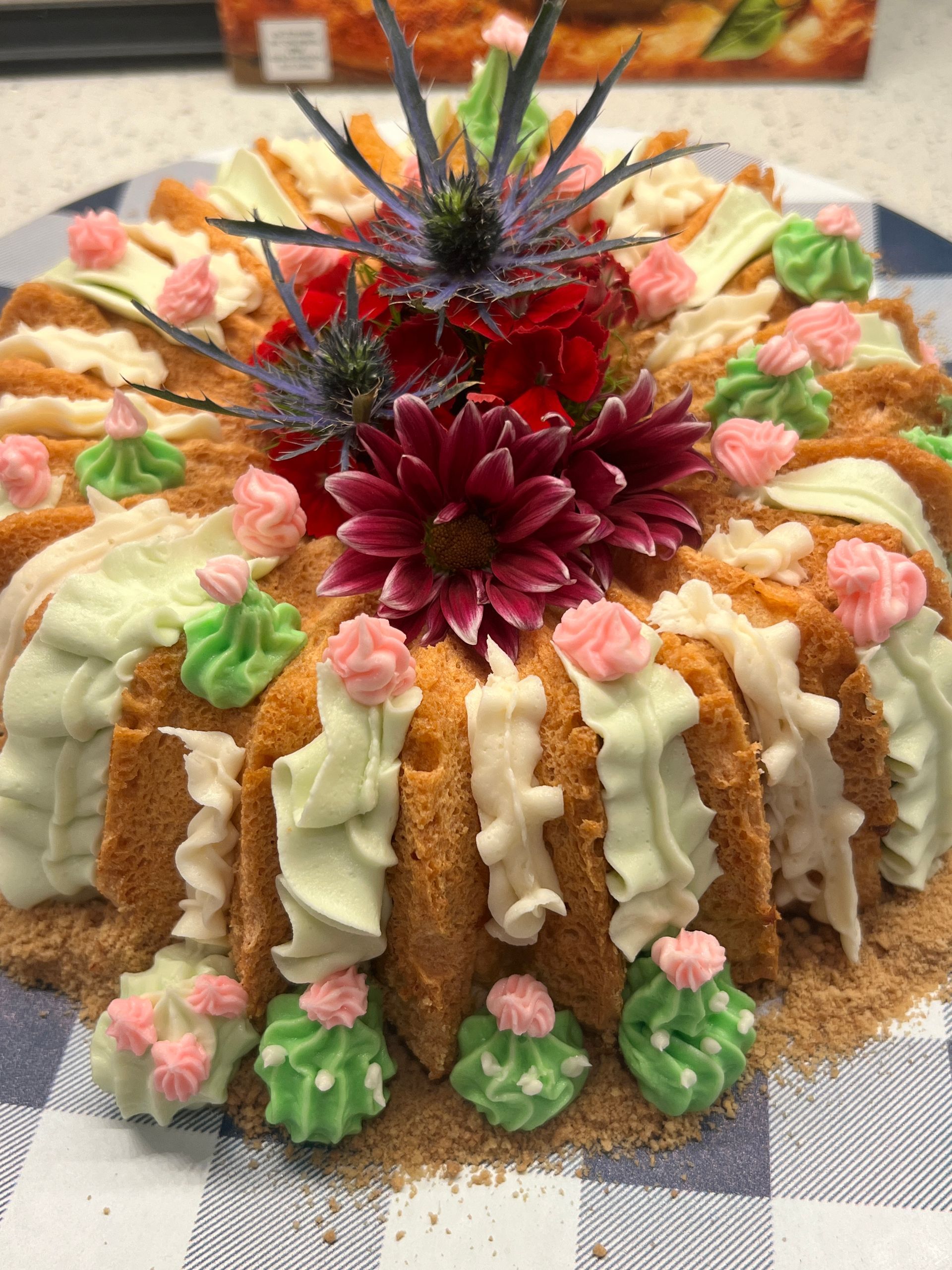 A bundt cake with flowers on top of it on a plate.