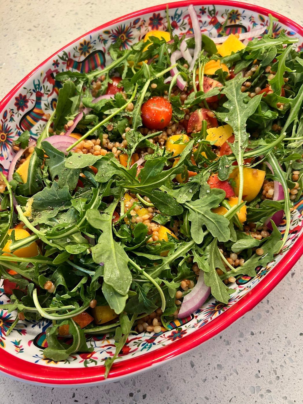 A close up of a salad in a bowl on a table.