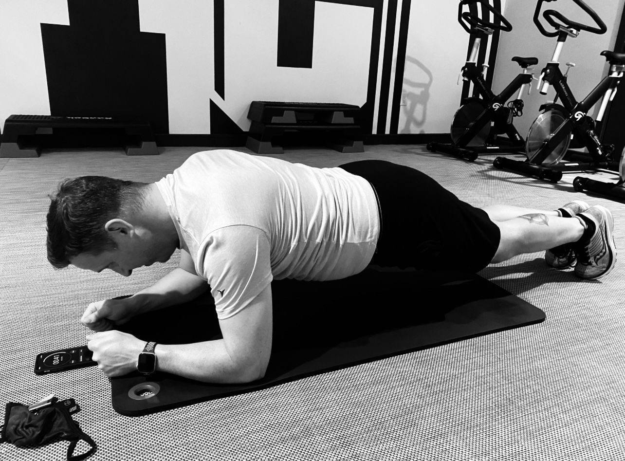 a man doing a plank on a yoga mat