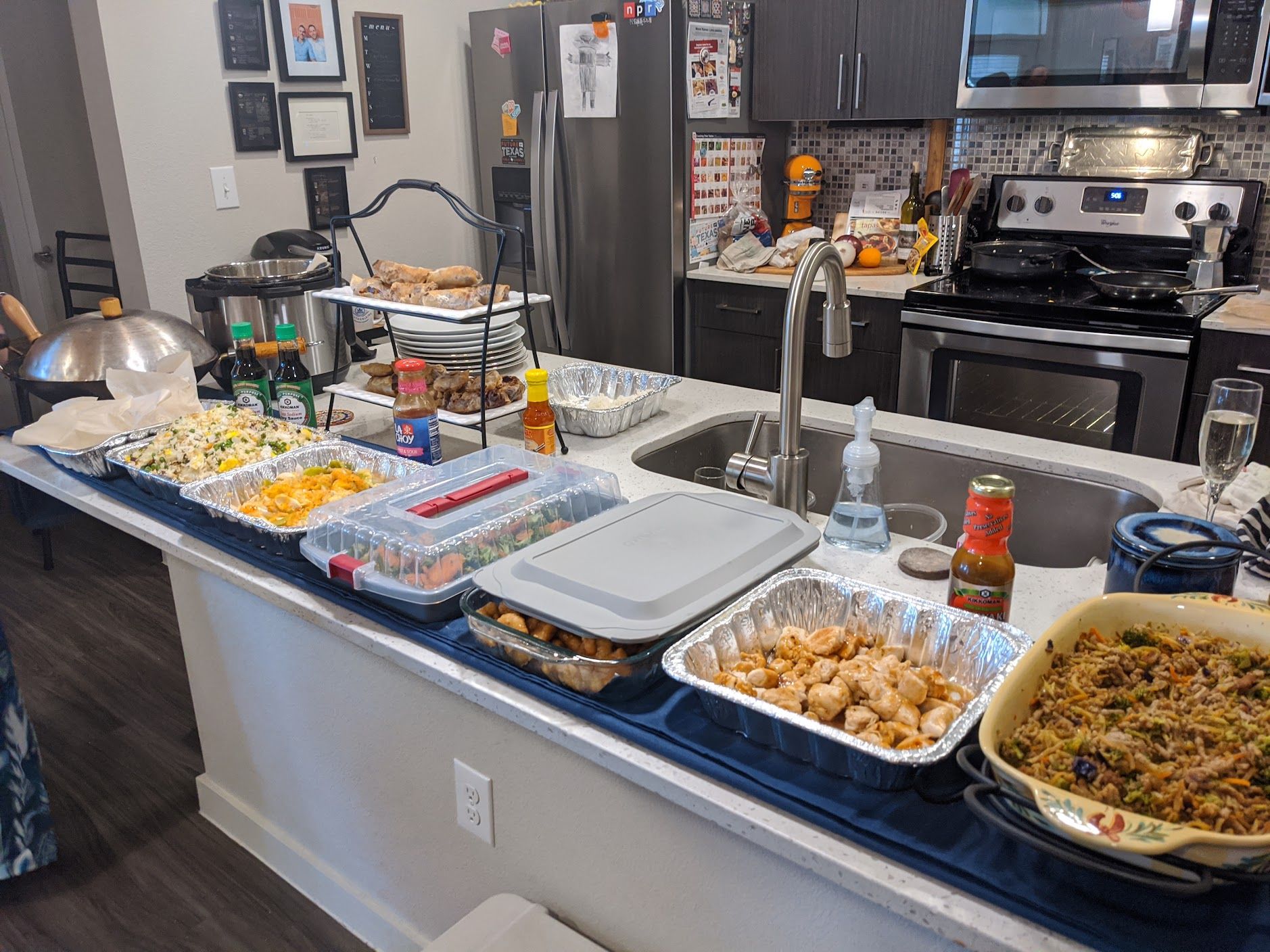 A kitchen counter filled with plates of food and a sink.