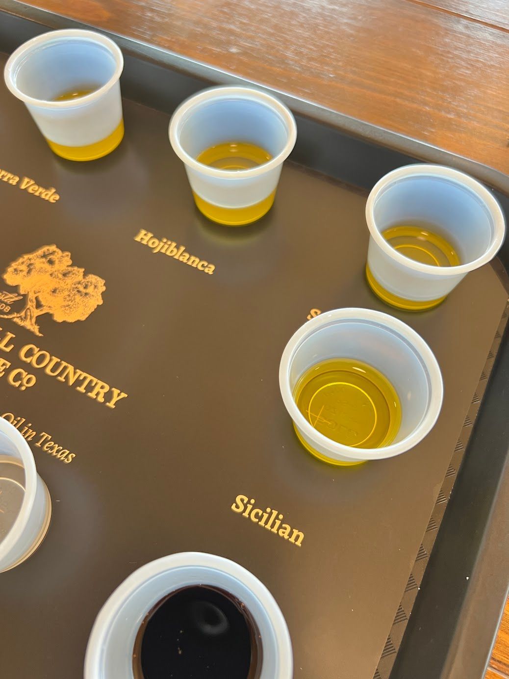 A tray with cups of different types of liquid on it