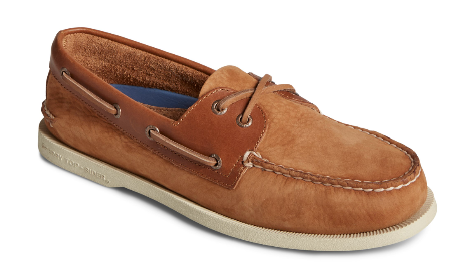A pair of brown boat shoes on a white background