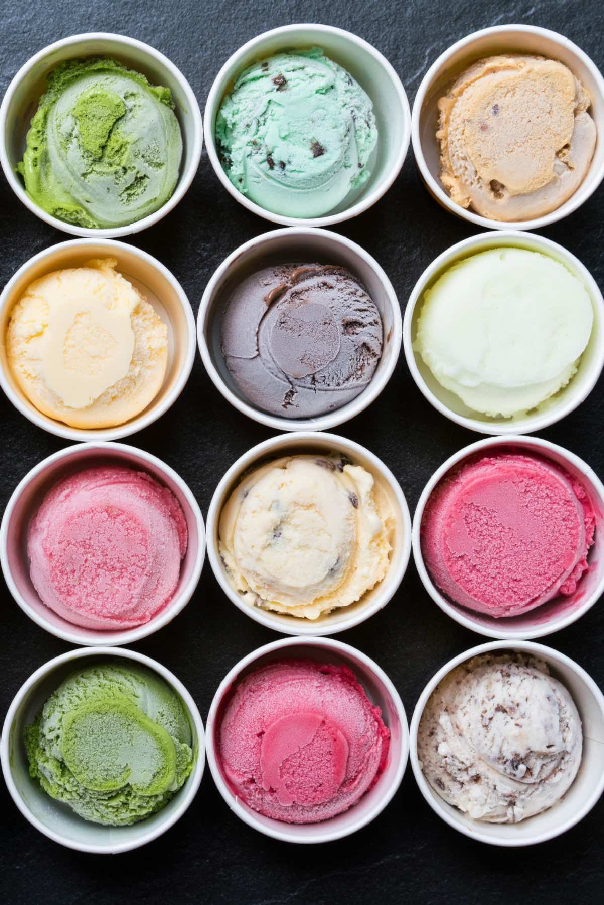 There are many different flavors of ice cream in the bowls.