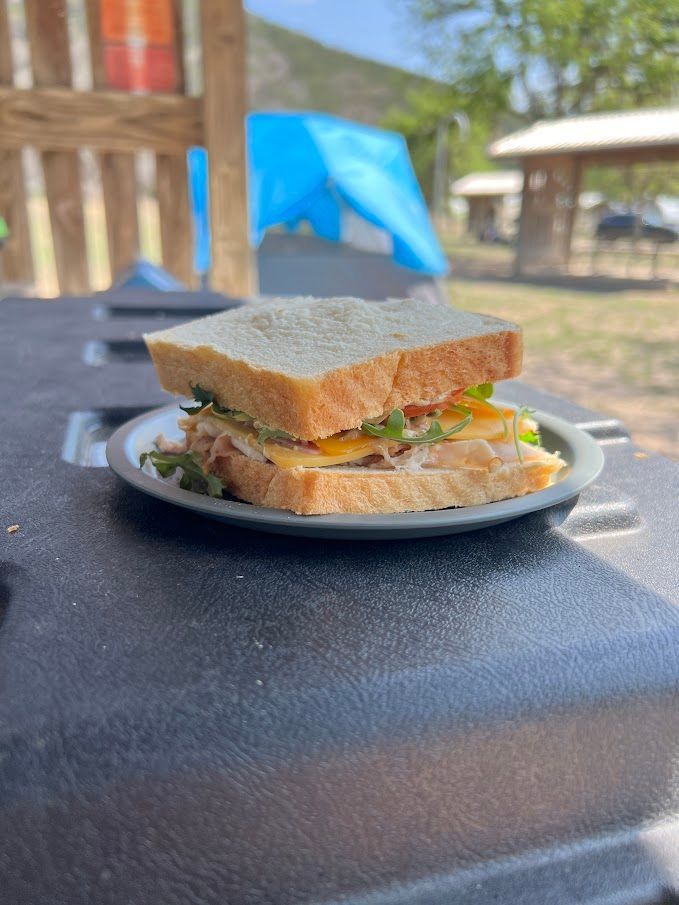 A sandwich is sitting on a plate on a table.