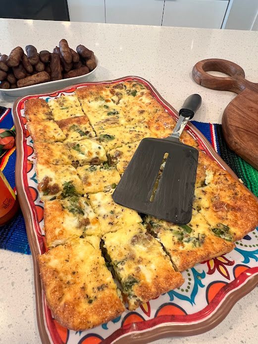 A pizza on a tray with a spatula on it