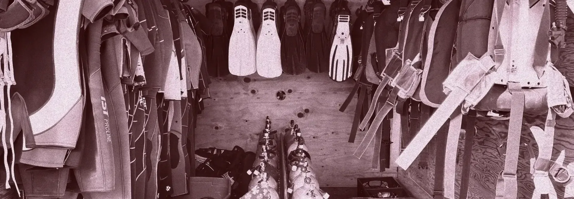 Rows of hanging clothes in a shop, with garments displayed from floor to ceiling.