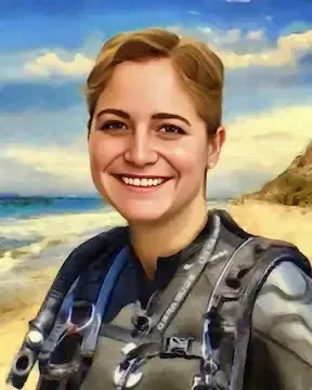 Smiling person in a gray flight suit standing in a desert landscape under a blue sky.