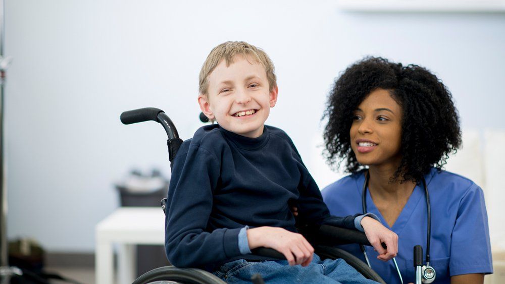 Smiling Boy On His Wheel Chair — Forsyth, NC — Safe Ride Transportation Smiling Boy On His Wheel Chair — Forsyth, NC — Safe Ride Transportation